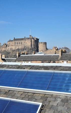 Solar panels on a slate building, looking across to Edinburgh Castle